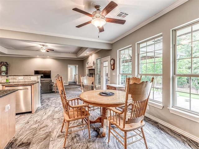 940908 S 3300th Rd, Luther, OK 73054 - dining area featuring a ceiling fan, healthy amount of natural light, crown molding, a tray ceiling, and light marble finish floors