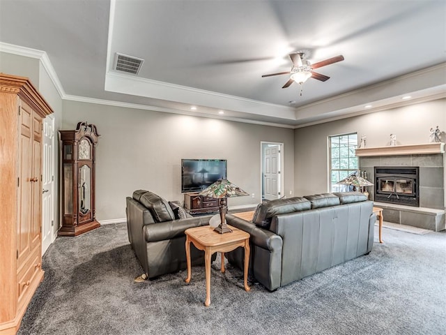 940908 S 3300th Rd, Luther, OK 73054 - living area featuring a tray ceiling, carpet, ceiling fan, crown molding, and a tile fireplace