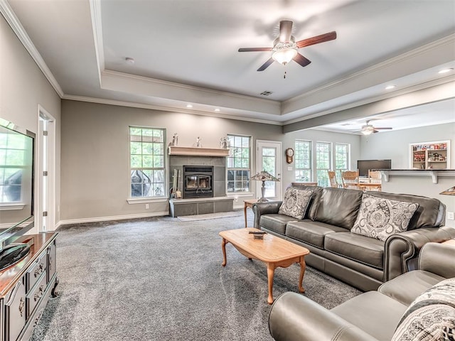 940908 S 3300th Rd, Luther, OK 73054 - carpeted living area featuring ceiling fan, a raised ceiling, crown molding, a tile fireplace, and recessed lighting