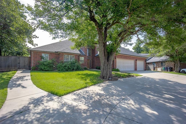 view of front of house featuring brick siding, a gate, driveway, and a garage