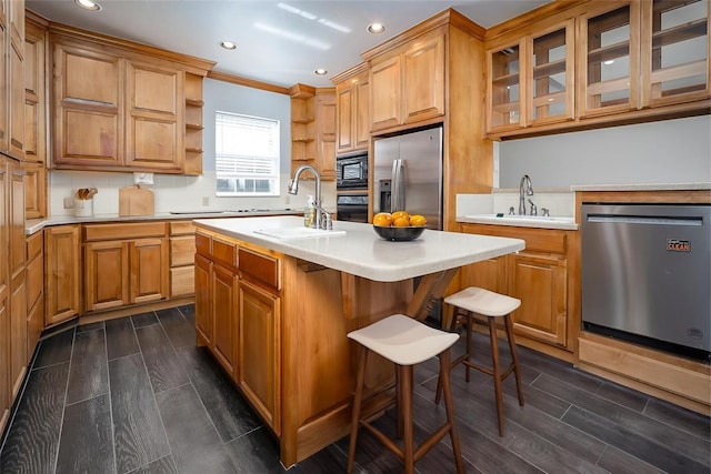 kitchen featuring black appliances, open shelves, light countertops, an island with sink, and wood finish floors