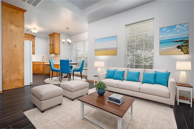 living area featuring wood finished floors and a chandelier