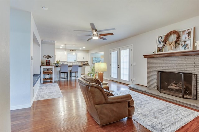 4813 NW 65th St, Oklahoma City, OK 73132 - living area featuring a ceiling fan, wood finished floors, and a brick fireplace