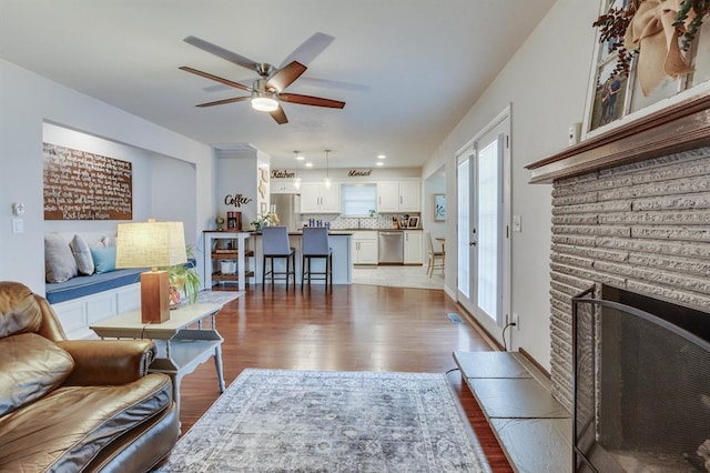 4813 NW 65th St, Oklahoma City, OK 73132 - living area with wood finished floors, a ceiling fan, and a fireplace