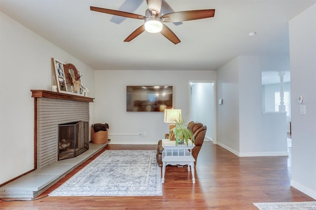4813 NW 65th St, Oklahoma City, OK 73132 - living room with a ceiling fan, wood finished floors, and a brick fireplace