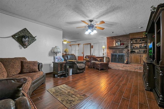1108 S 13th St, Clinton, OK 73601 - living room featuring ceiling fan, dark wood-type flooring, a textured ceiling, and a fireplace