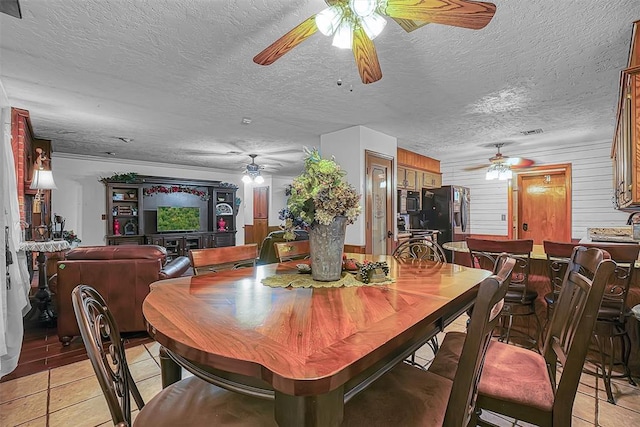 1108 S 13th St, Clinton, OK 73601 - dining space featuring a ceiling fan, light tile patterned flooring, and a textured ceiling