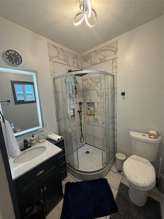 1522 S 9th St, Chickasha, OK 73018 - bathroom featuring vanity and a shower stall