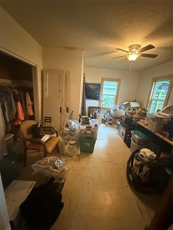 1522 S 9th St, Chickasha, OK 73018 - miscellaneous room with a ceiling fan, a textured ceiling, and carpet floors