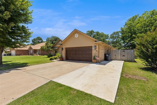 5 Larkens Pl, Shawnee, OK 74801 - view of front of house with a garage, brick siding, concrete driveway, and a gate