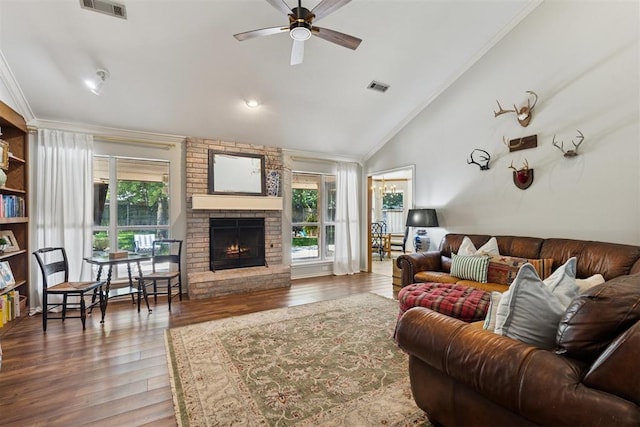 5 Larkens Pl, Shawnee, OK 74801 - living room featuring a ceiling fan, wood finished floors, a fireplace, ornamental molding, and vaulted ceiling