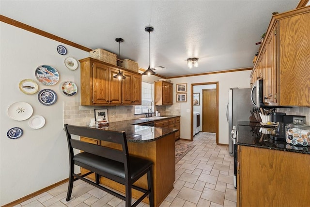 5 Larkens Pl, Shawnee, OK 74801 - kitchen with a peninsula, backsplash, brown cabinetry, a breakfast bar, and dark stone counters