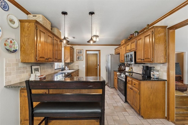 5 Larkens Pl, Shawnee, OK 74801 - kitchen with appliances with stainless steel finishes, decorative backsplash, crown molding, brown cabinetry, and a peninsula