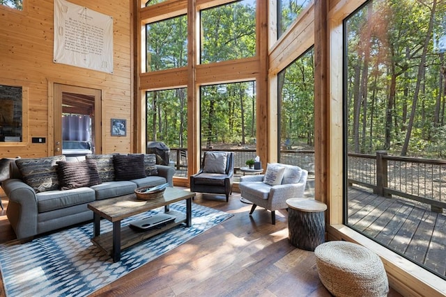173 Guppy Ln, Hochatown, OK 74728 - living area featuring wooden walls, wood finished floors, and a high ceiling