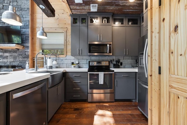 173 Guppy Ln, Hochatown, OK 74728 - kitchen with stainless steel appliances, gray cabinetry, dark wood finished floors, glass insert cabinets, and light countertops