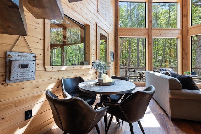 173 Guppy Ln, Hochatown, OK 74728 - dining room with wooden walls, plenty of natural light, and wood finished floors