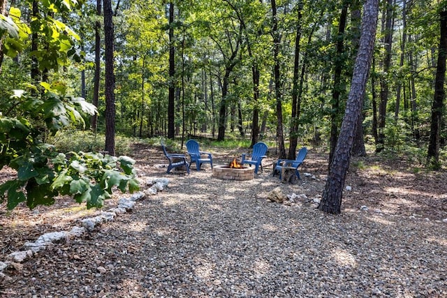 173 Guppy Ln, Hochatown, OK 74728 - view of yard with an outdoor fire pit and a view of trees