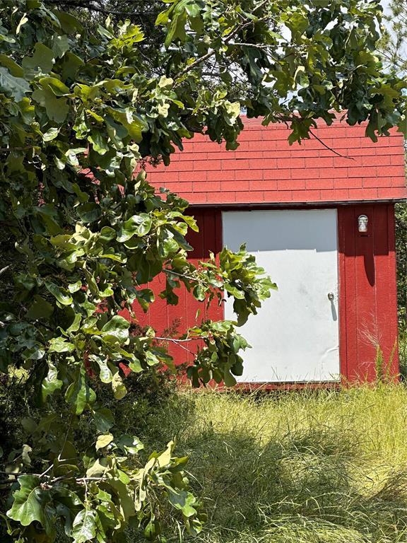 182424 N 4159th Rd, Moyers, OK 74557 - garage featuring a storage unit