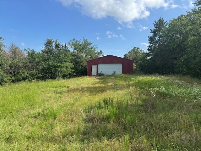182424 N 4159th Rd, Moyers, OK 74557 - view of yard with a detached garage, an outbuilding, and a forest view