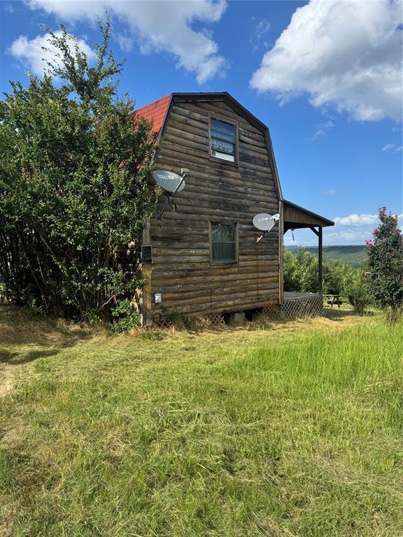 182424 N 4159th Rd, Moyers, OK 74557 - view of home's exterior with a gambrel roof, an outdoor structure, and a barn