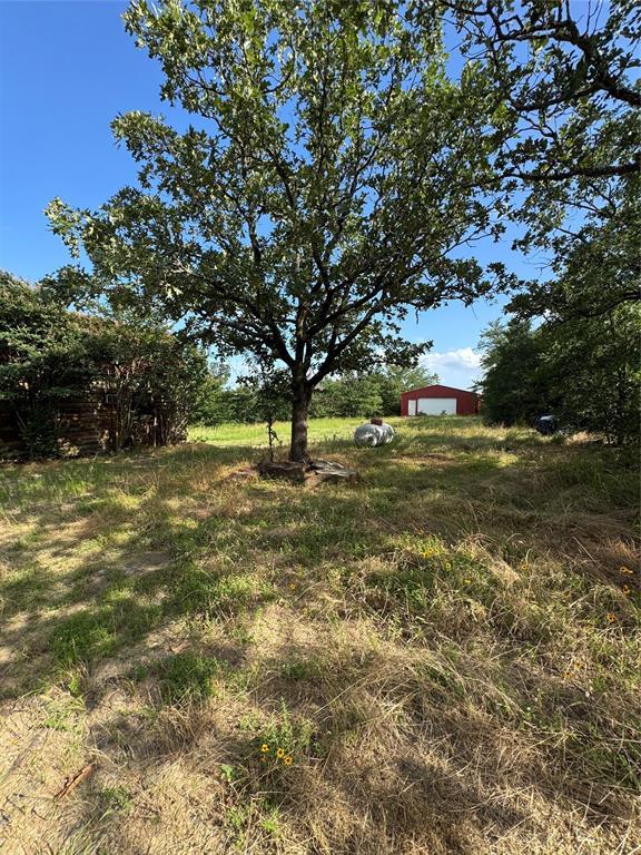 182424 N 4159th Rd, Moyers, OK 74557 - view of yard featuring a detached garage and an outbuilding