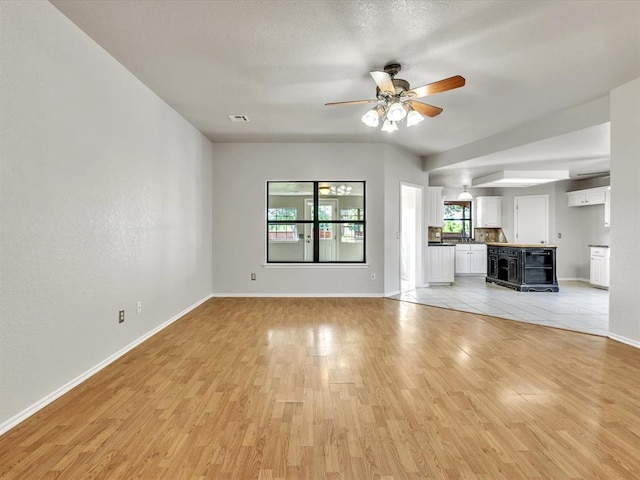 4001 Tori Pl, Yukon, OK 73099 - unfurnished living room featuring light wood finished floors and ceiling fan