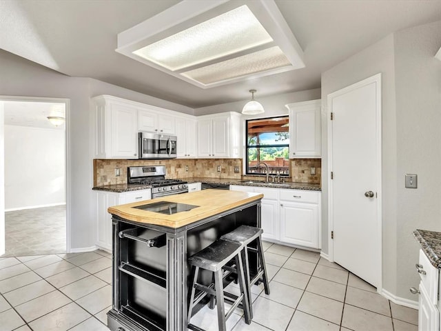 4001 Tori Pl, Yukon, OK 73099 - kitchen featuring appliances with stainless steel finishes, butcher block counters, decorative backsplash, and white cabinetry