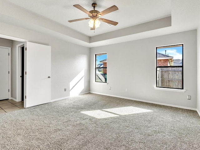 4001 Tori Pl, Yukon, OK 73099 - spare room featuring carpet flooring, a raised ceiling, and ceiling fan
