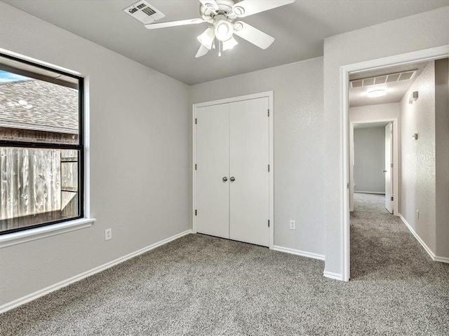 4001 Tori Pl, Yukon, OK 73099 - unfurnished bedroom featuring carpet flooring, multiple windows, a closet, and ceiling fan