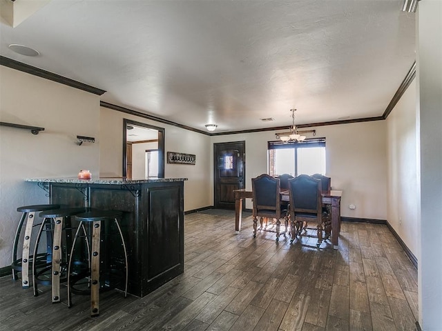 5053 Northridge Run, Cashion, OK 73016 - dining area with ornamental molding, dark wood-style floors, and a chandelier