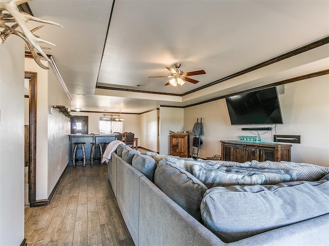 5053 Northridge Run, Cashion, OK 73016 - living room with ornamental molding, a ceiling fan, hardwood / wood-style floors, and a tray ceiling