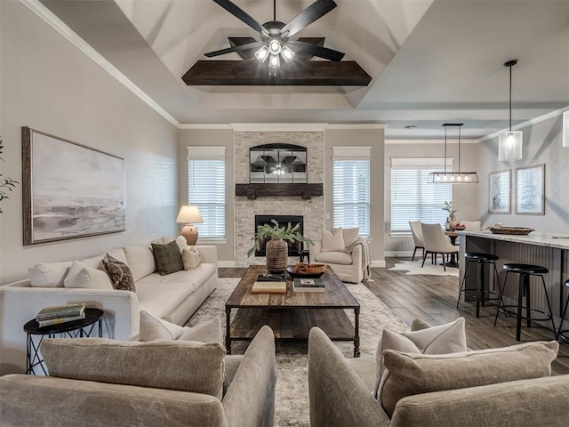 11716 SW 47th St, Mustang, OK 73064 - living area with wood finished floors, ceiling fan, a raised ceiling, crown molding, and a fireplace