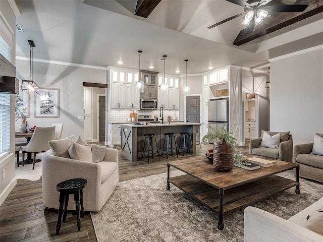 11716 SW 47th St, Mustang, OK 73064 - living area featuring dark wood-style flooring, recessed lighting, a ceiling fan, crown molding, and healthy amount of natural light