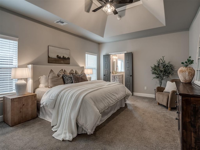 11716 SW 47th St, Mustang, OK 73064 - carpeted bedroom with a raised ceiling, connected bathroom, and ceiling fan