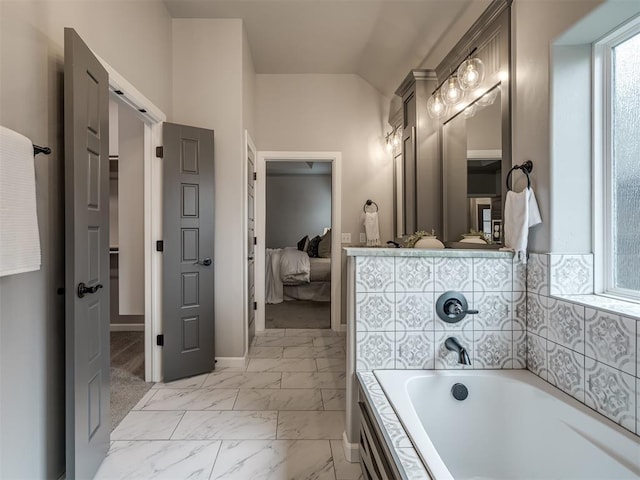 11716 SW 47th St, Mustang, OK 73064 - ensuite bathroom featuring a bath, marble look tile flooring, a closet, and lofted ceiling