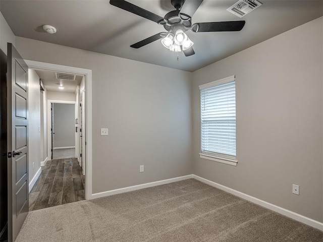 11716 SW 47th St, Mustang, OK 73064 - empty room with a smoke detector, a ceiling fan, and dark carpet