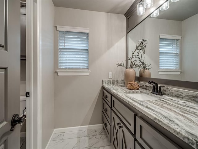 11716 SW 47th St, Mustang, OK 73064 - bathroom featuring vanity and marble look tile flooring