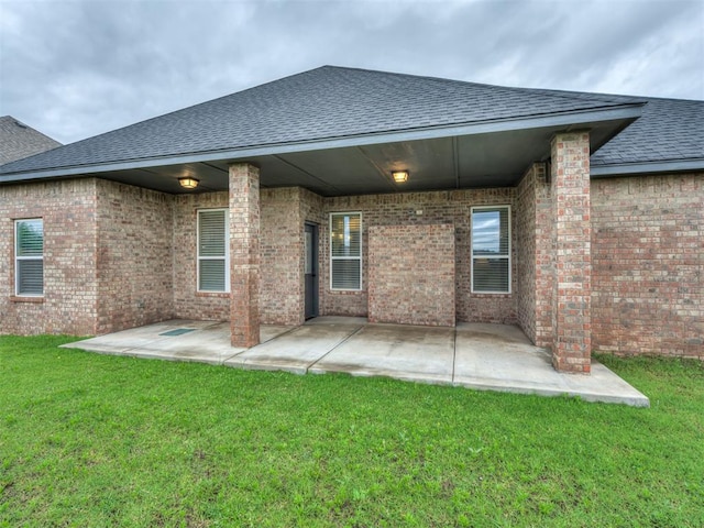11716 SW 47th St, Mustang, OK 73064 - back of house with a shingled roof, a patio area, and a yard