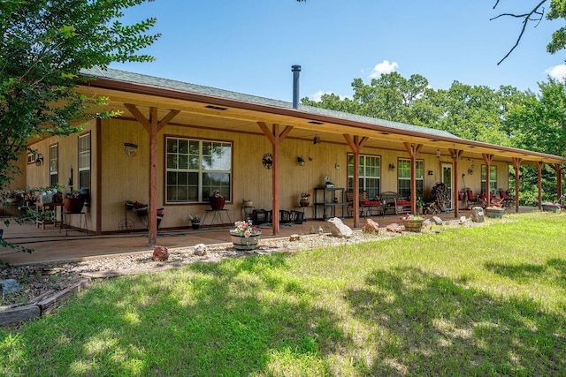 12333 E Tecumseh Rd, Norman, OK 73026 - rear view of property featuring a lawn
