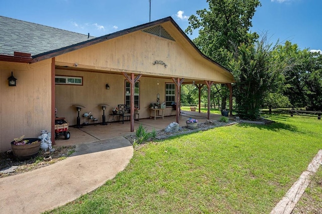 12333 E Tecumseh Rd, Norman, OK 73026 - back of property featuring a yard, a shingled roof, and a patio area