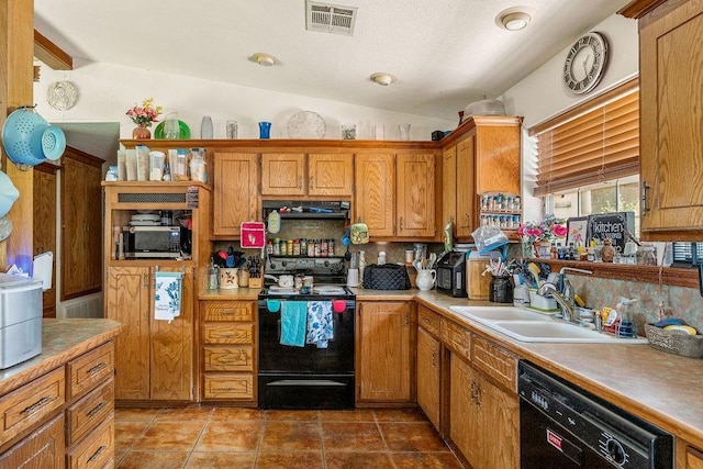 12333 E Tecumseh Rd, Norman, OK 73026 - kitchen with black appliances, under cabinet range hood, brown cabinets, decorative backsplash, and light countertops