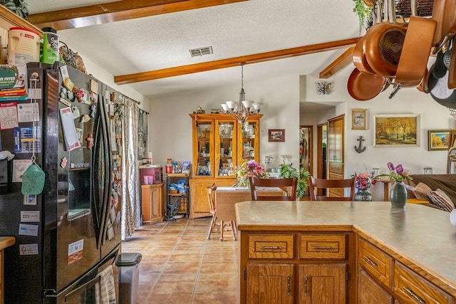 12333 E Tecumseh Rd, Norman, OK 73026 - kitchen featuring freestanding refrigerator, beam ceiling, a chandelier, pendant lighting, and light tile patterned floors