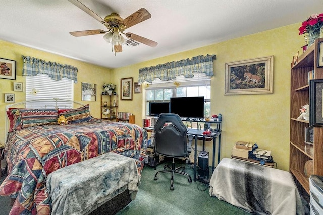 12333 E Tecumseh Rd, Norman, OK 73026 - carpeted bedroom featuring multiple windows, an office area, and a ceiling fan