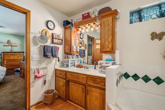 12333 E Tecumseh Rd, Norman, OK 73026 - bathroom with a garden tub, vanity, and connected bathroom