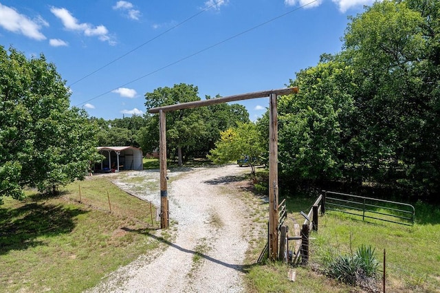 12333 E Tecumseh Rd, Norman, OK 73026 - view of yard with a detached carport and driveway