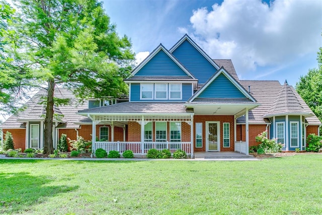 11748 SW 54th St, Mustang, OK 73064 - view of front of house with brick siding, a porch, and a front yard