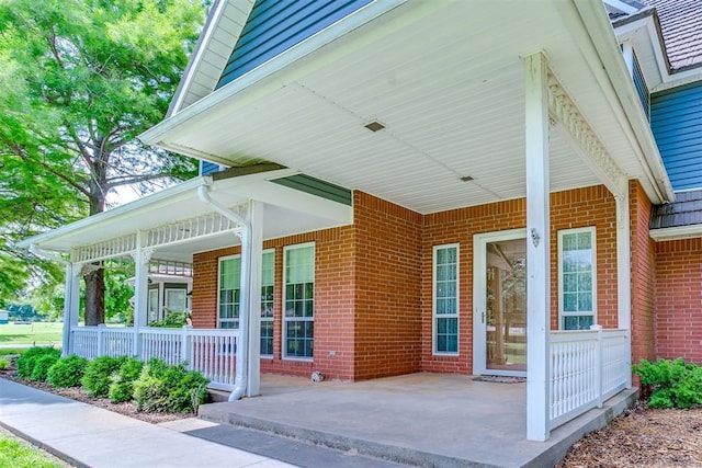 11748 SW 54th St, Mustang, OK 73064 - property entrance featuring brick siding and covered porch