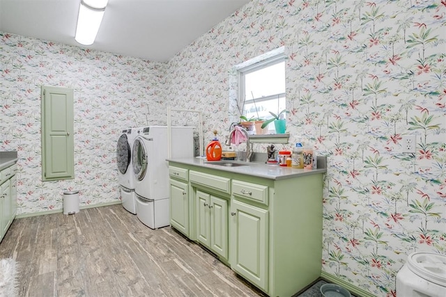 11748 SW 54th St, Mustang, OK 73064 - laundry area featuring light wood finished floors, wallpapered walls, separate washer and dryer, and cabinet space