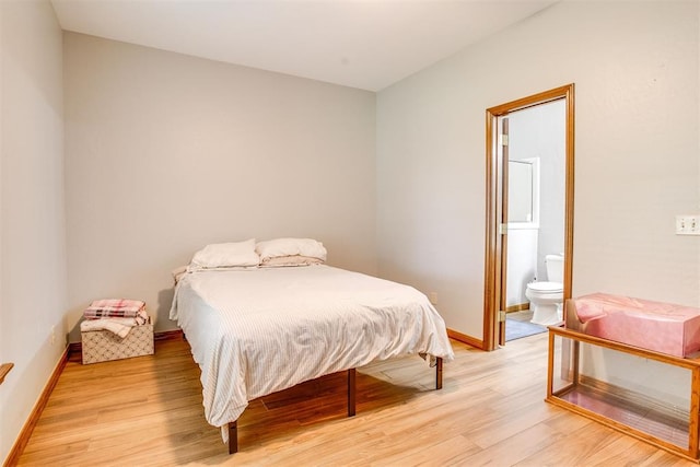 11748 SW 54th St, Mustang, OK 73064 - bedroom with light wood finished floors and connected bathroom