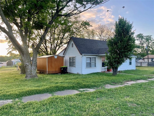 529 Lester Ln, Purcell, OK 73080 - property exterior at dusk with a shed and a shingled roof